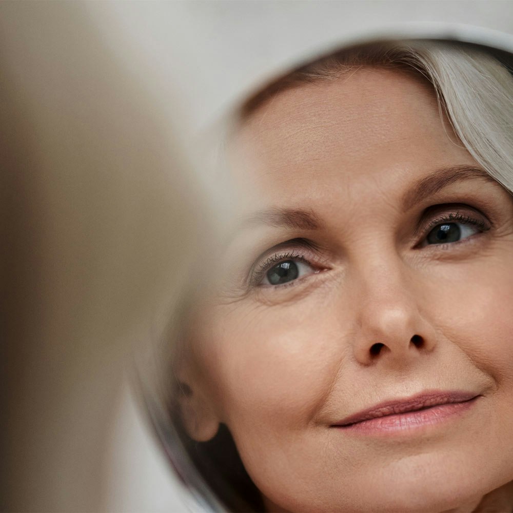 Older woman looking in mirror